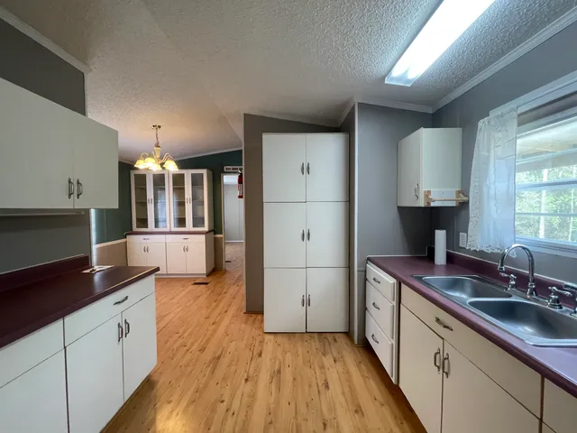 a kitchen with a sink and refrigerator