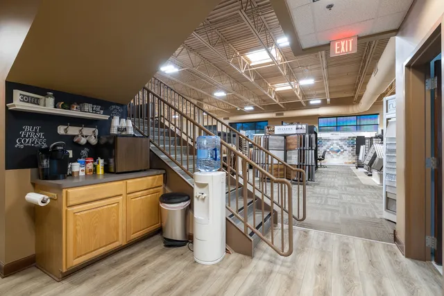 a view of a workspace with furniture and a window