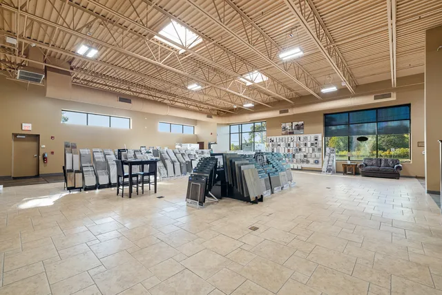 a view of a hallway with a table and chairs