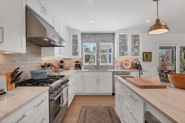 a kitchen with a sink stove and cabinets