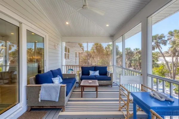 a living room with furniture and a floor to ceiling window