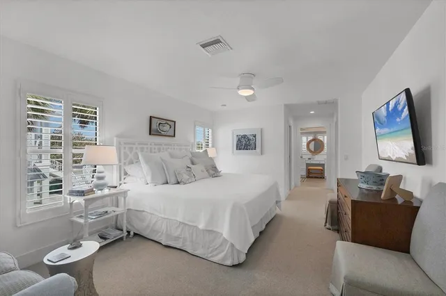 a bedroom with a bed and glass window
