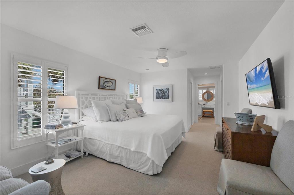 355 Barbarossa Street Boca Grande, FL 33921 - Photo 19 of 47 a bedroom with a bed and glass window