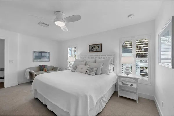 a bedroom with a large bed and a chandelier