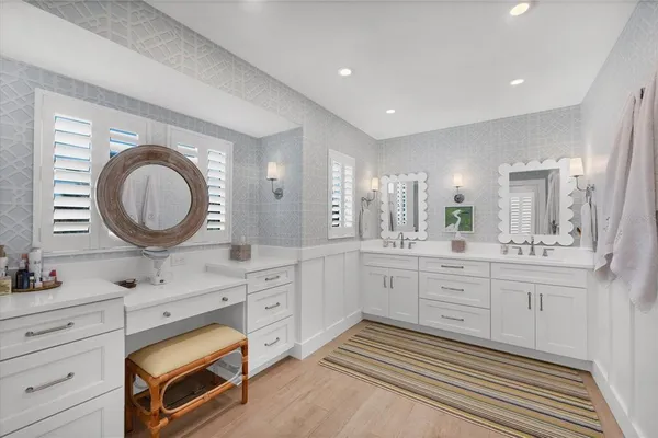 a spacious bathroom with a granite countertop sink a mirror and a