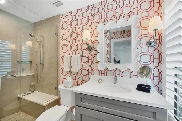a bathroom with a sink a toilet and shower curtain