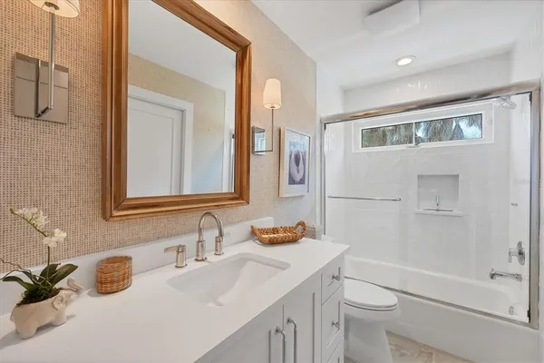 a bathroom with a sink toilet tub and shower