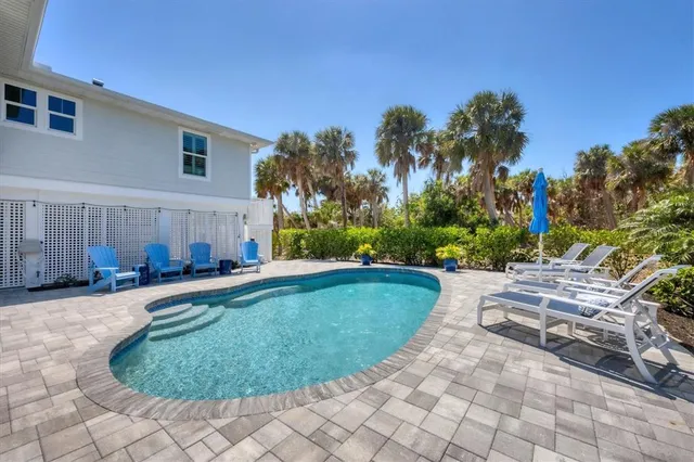 a view of a swimming pool with lounge chair