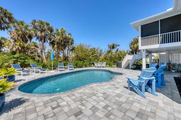 a view of a swimming pool with sitting area