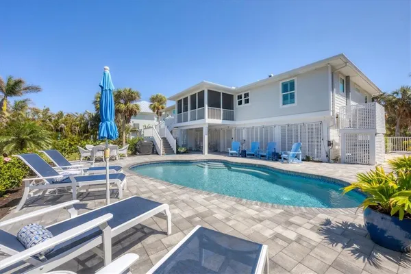 a view of a house with backyard and sitting area