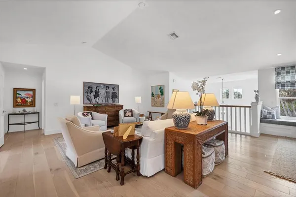 a living room with fireplace furniture and a wooden floor
