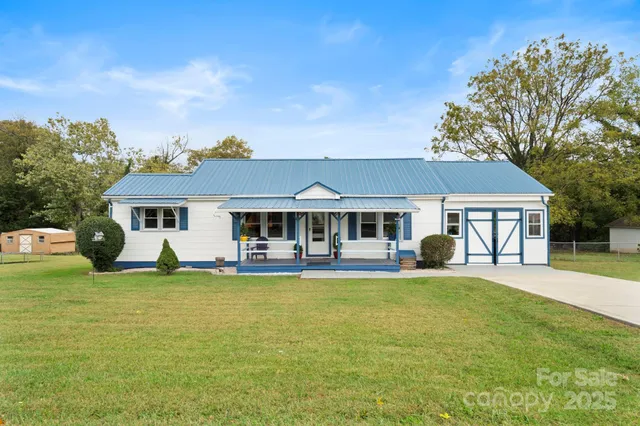 a view of a house with swimming pool and a yard