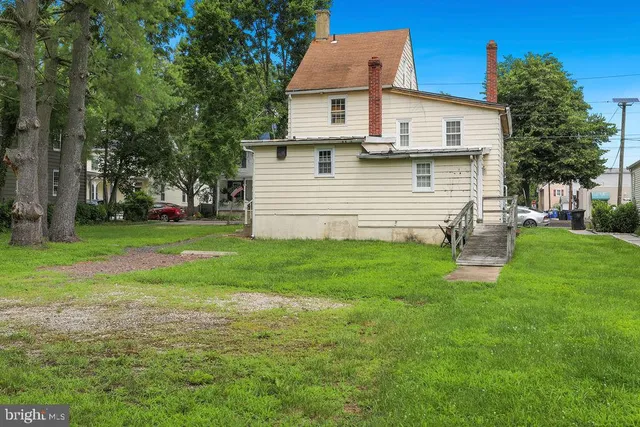a view of a house with a yard and sitting area