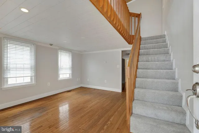 a view of an entryway with wooden floor and door