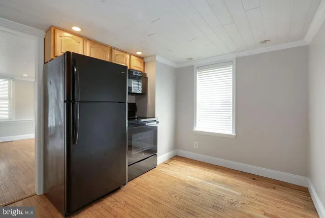 a kitchen with a refrigerator and a refrigerator