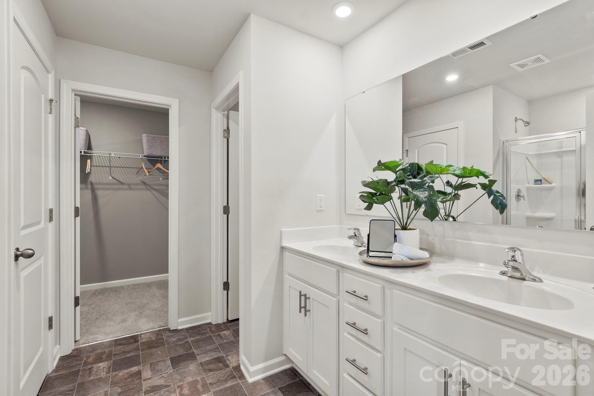 8034 Midas Lane Locust, NC 28097 - Photo 18 of 27 a bathroom with a granite countertop sink a mirror and a shower