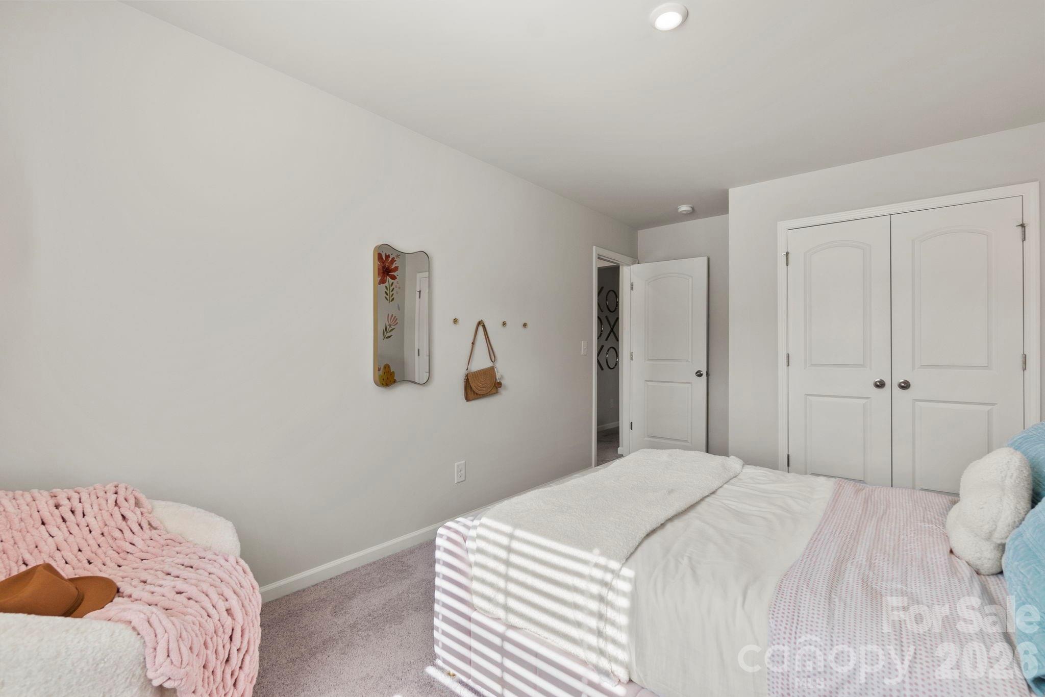8034 Midas Lane Locust, NC 28097 - Photo 24 of 27 a bedroom with a bed and a closet