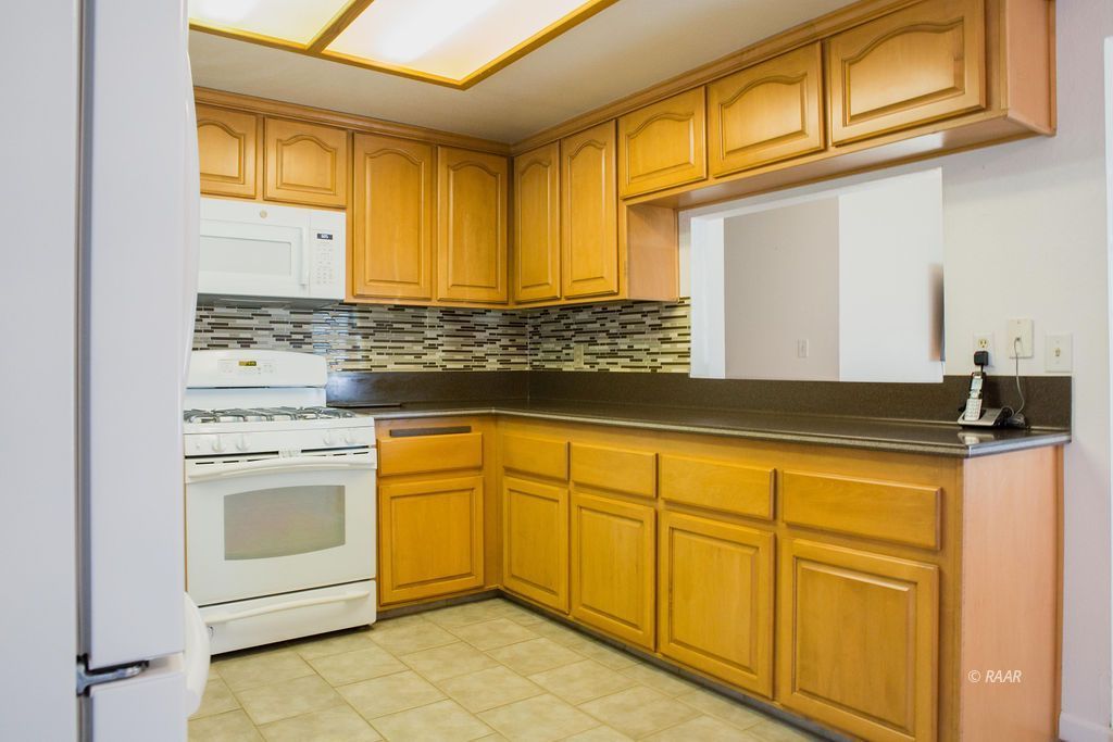 620 Heather Court Ridgecrest, CA 93555 - Photo 10 of 26 a kitchen with stainless steel appliances granite countertop a sink stove and cabinets