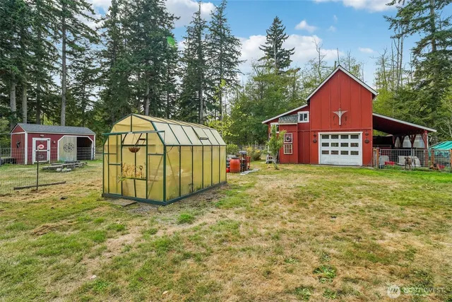 a view of a house with a yard and a wooden deck