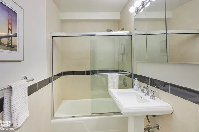 a kitchen with a refrigerator sink and cabinets