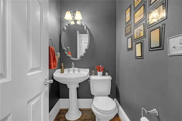 a bathroom with a toilet a sink and a mirror