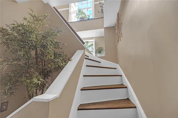 a view of staircase with wooden floor and stairs