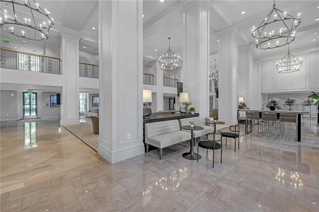 30 5th Street Northeast, Unit 102 Atlanta, GA 30308 - Photo 20 of 25 a living room with furniture and a chandelier