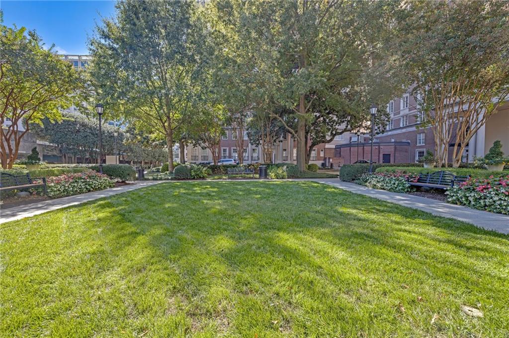 30 5th Street Northeast, Unit 102 Atlanta, GA 30308 - Photo 21 of 25 a swimming pool with outdoor seating and yard