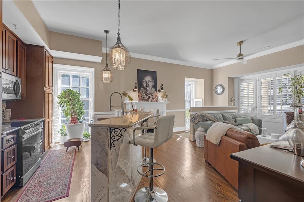 30 5th Street Northeast, Unit 102 Atlanta, GA 30308 - Photo 3 of 25 a view of a dining room with furniture window and wooden floor