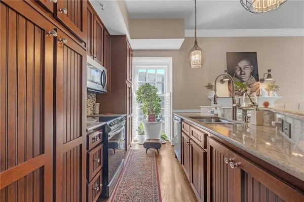 a kitchen with sink stove and cabinets