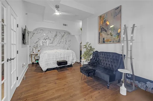 a living room with furniture and wooden floor