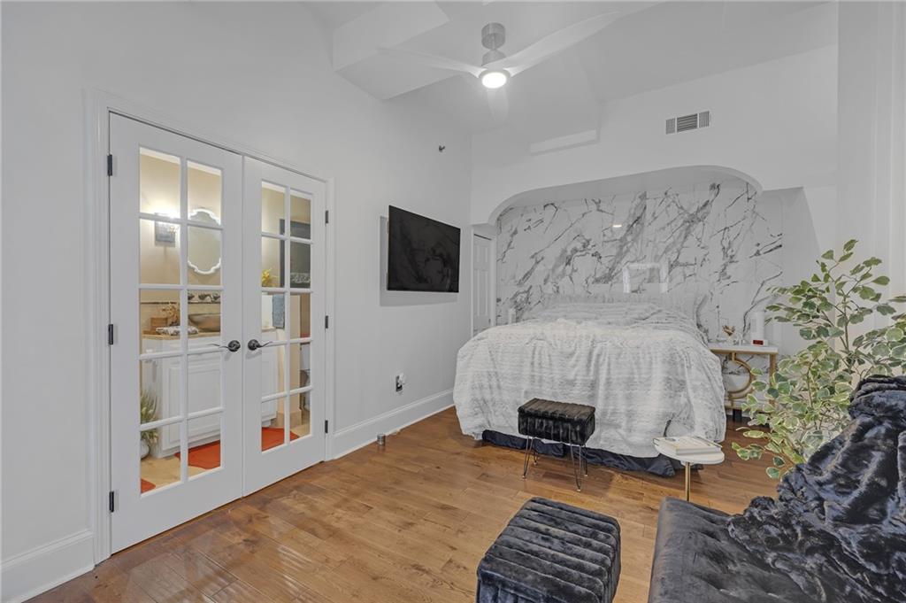 30 5th Street Northeast, Unit 102 Atlanta, GA 30308 - Photo 9 of 25 a bedroom with furniture and a fireplace