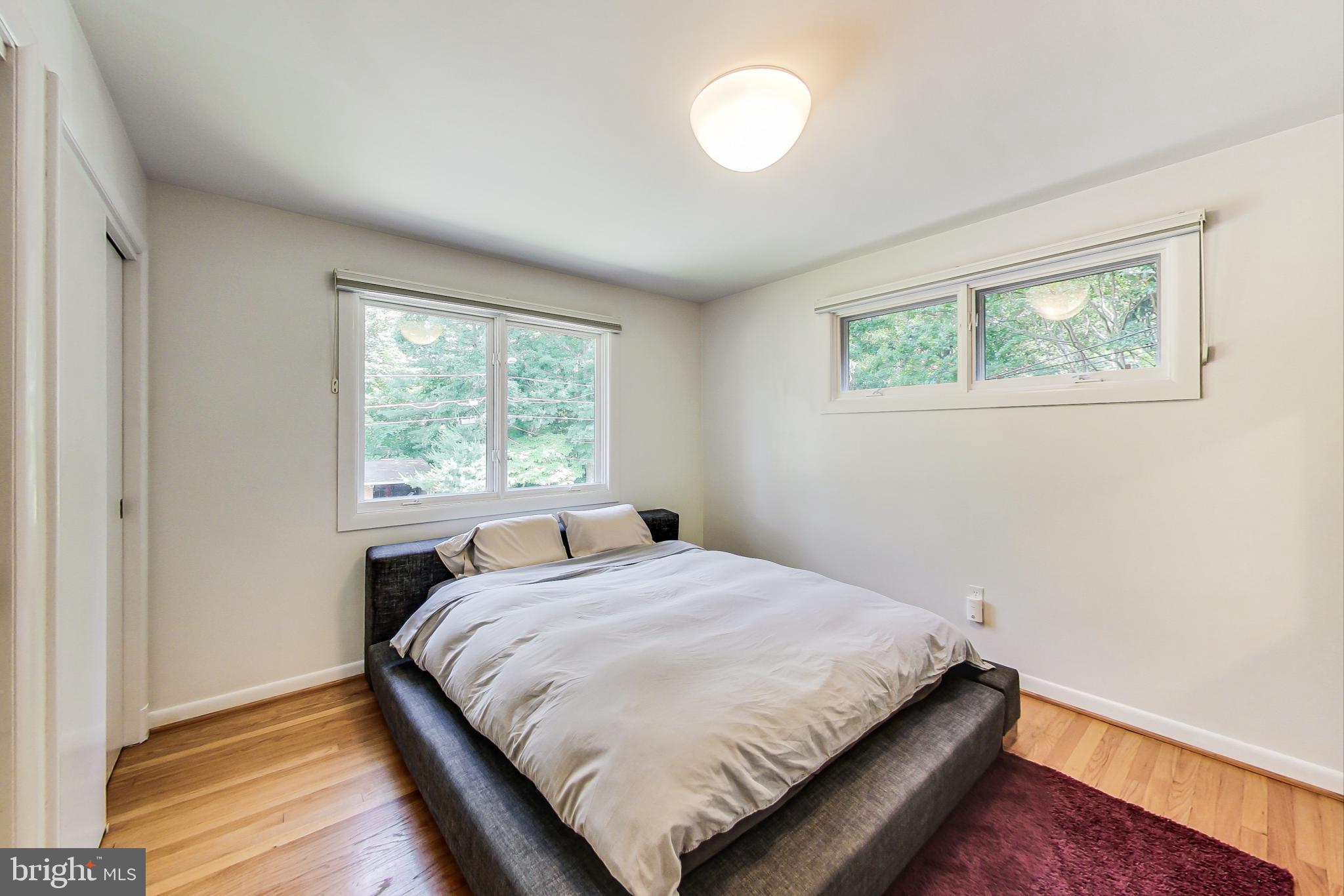 6515 East Halbert Road Bethesda, MD 20817 - Photo 24 of 42 a bed sitting in a bedroom next to a window