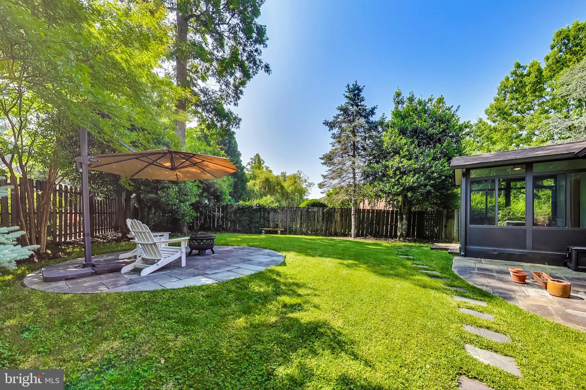 6515 East Halbert Road Bethesda, MD 20817 - Photo 41 of 42 a view of a backyard with table and chairs under an umbrella