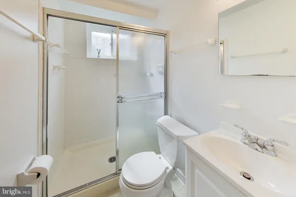 a white toilet sitting next to a bathroom sink