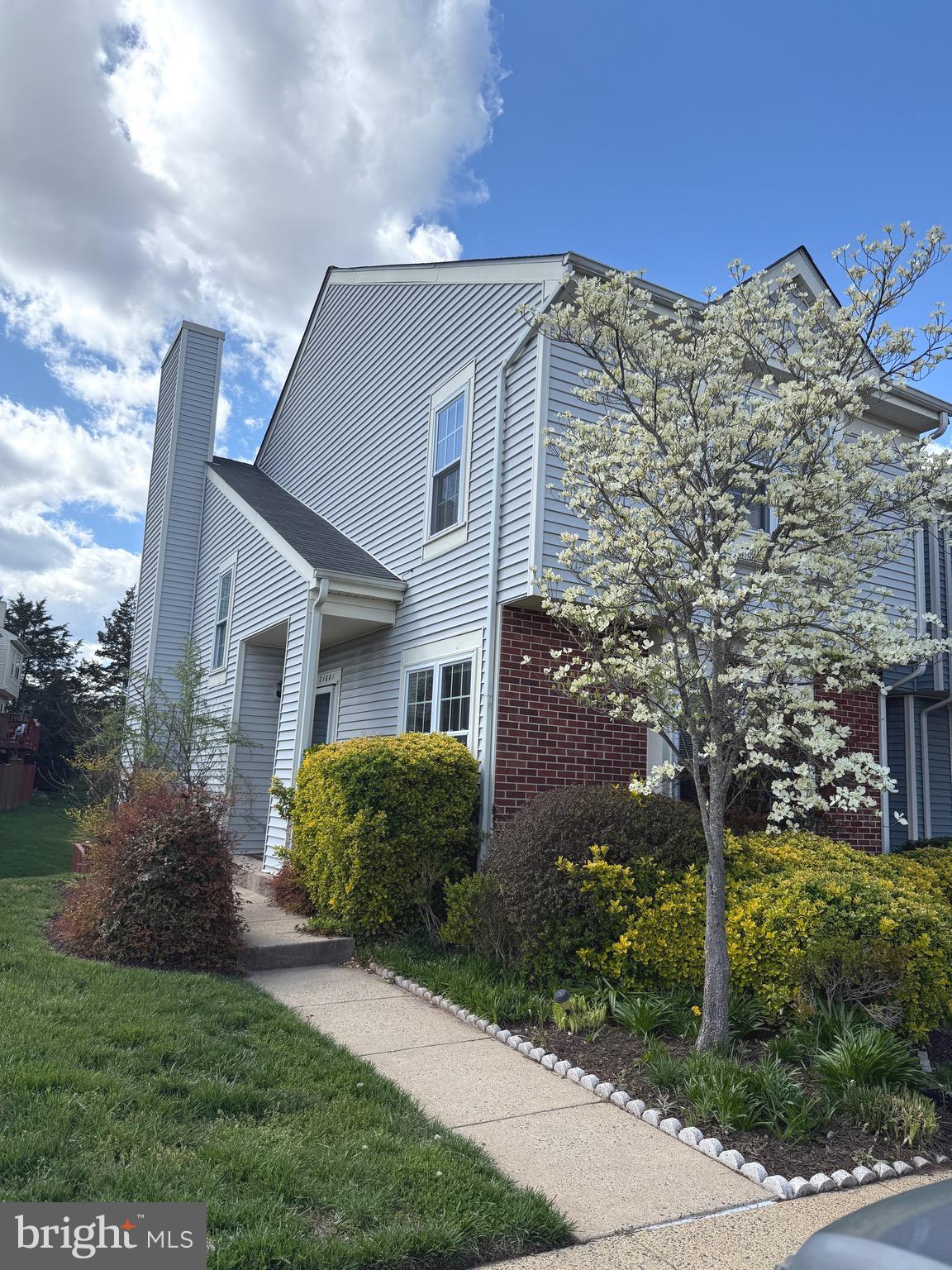21681 Hazelnut Square, Unit 168 Sterling, VA 20164 - Photo 2 of 35 a front view of a house with a garden
