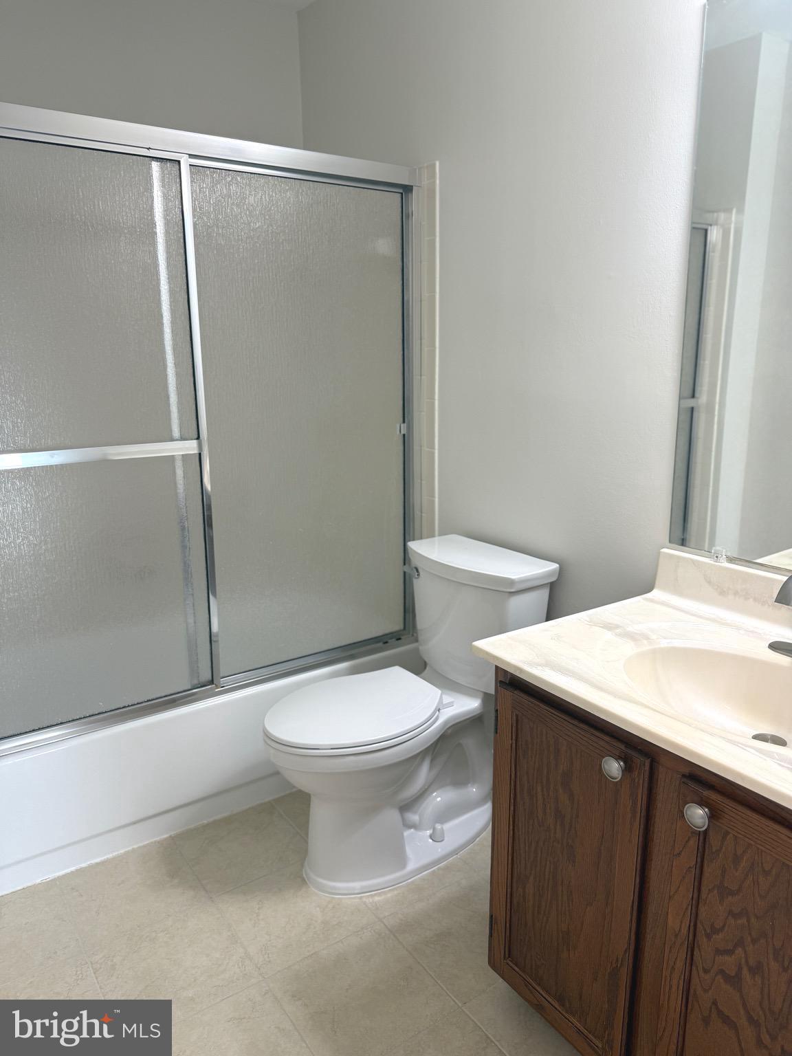 21681 Hazelnut Square, Unit 168 Sterling, VA 20164 - Photo 21 of 35 a white toilet sitting next to a bathroom sink