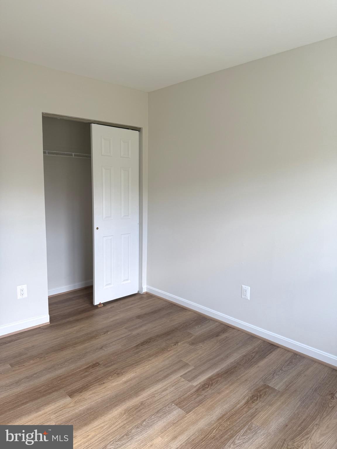 21681 Hazelnut Square, Unit 168 Sterling, VA 20164 - Photo 25 of 35 a view of an empty room with wooden floor