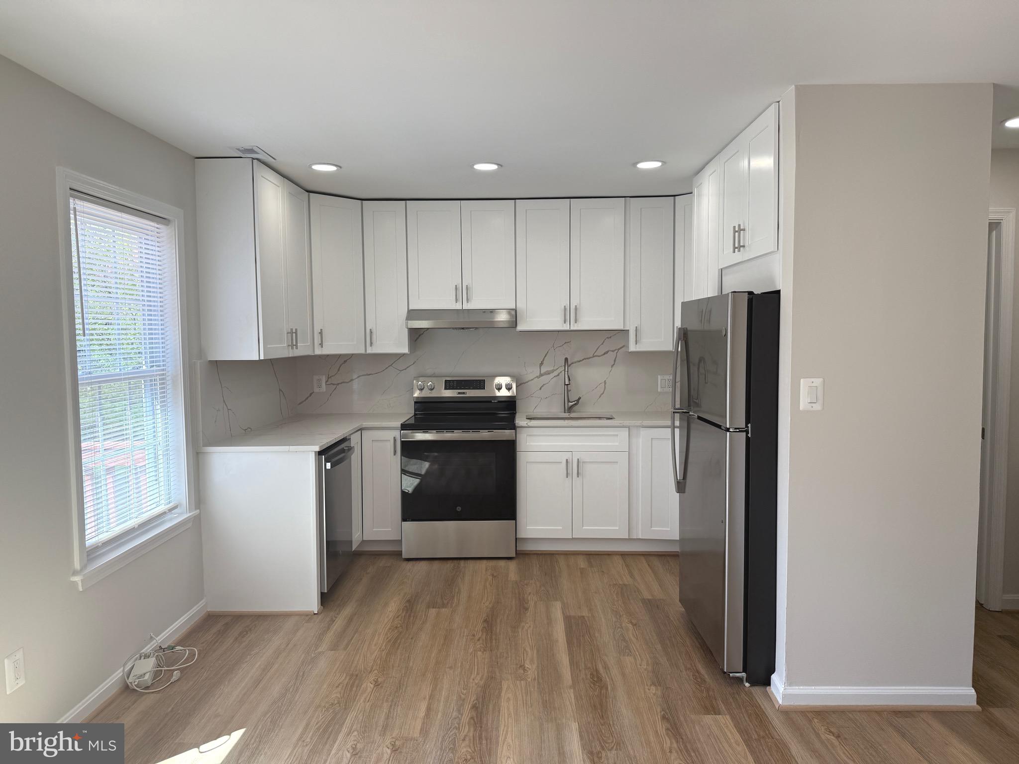 21681 Hazelnut Square, Unit 168 Sterling, VA 20164 - Photo 29 of 35 a kitchen with a refrigerator and a stove top oven