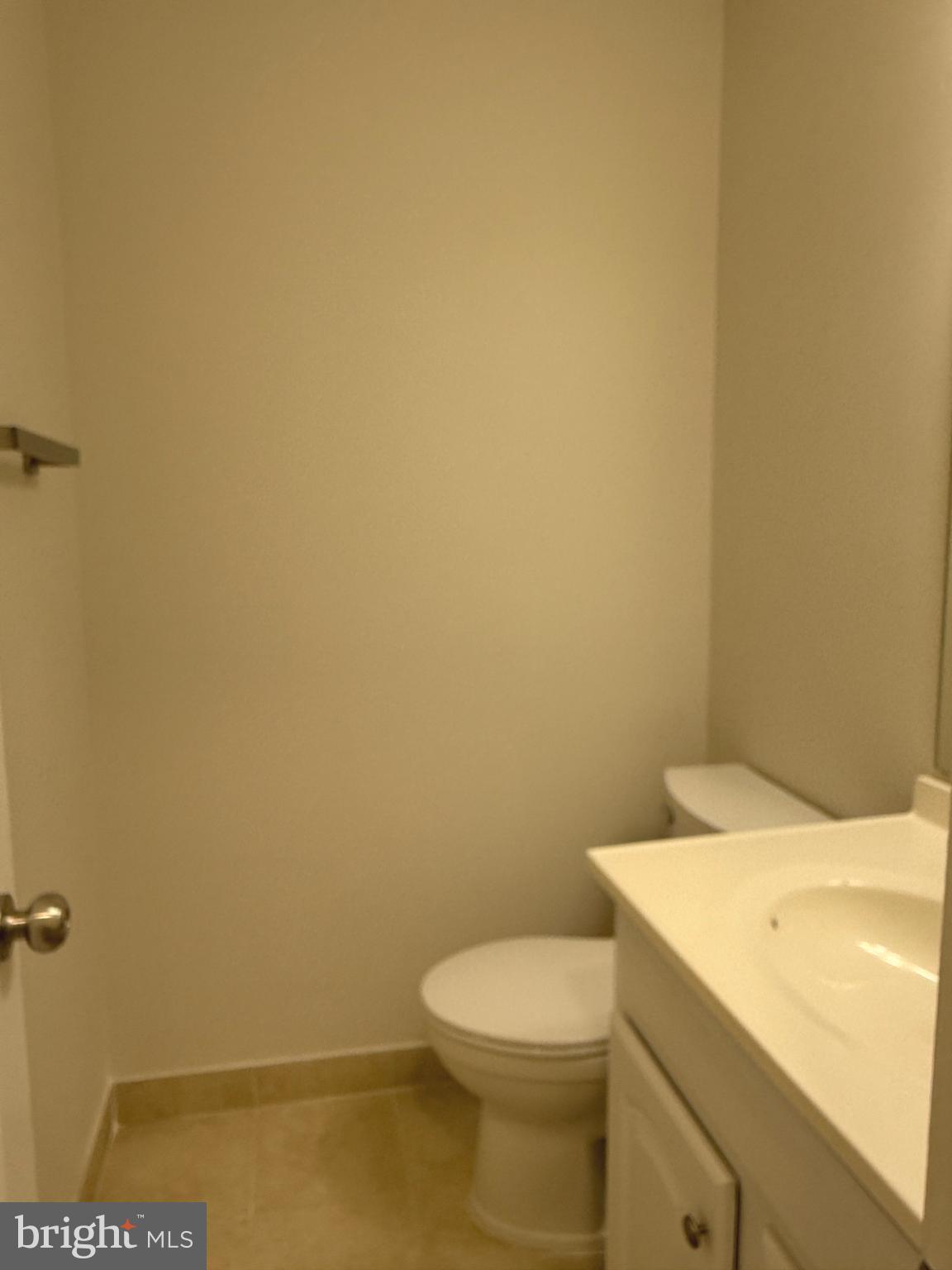 21681 Hazelnut Square, Unit 168 Sterling, VA 20164 - Photo 31 of 35 a white toilet sitting next to a white sink and vanity