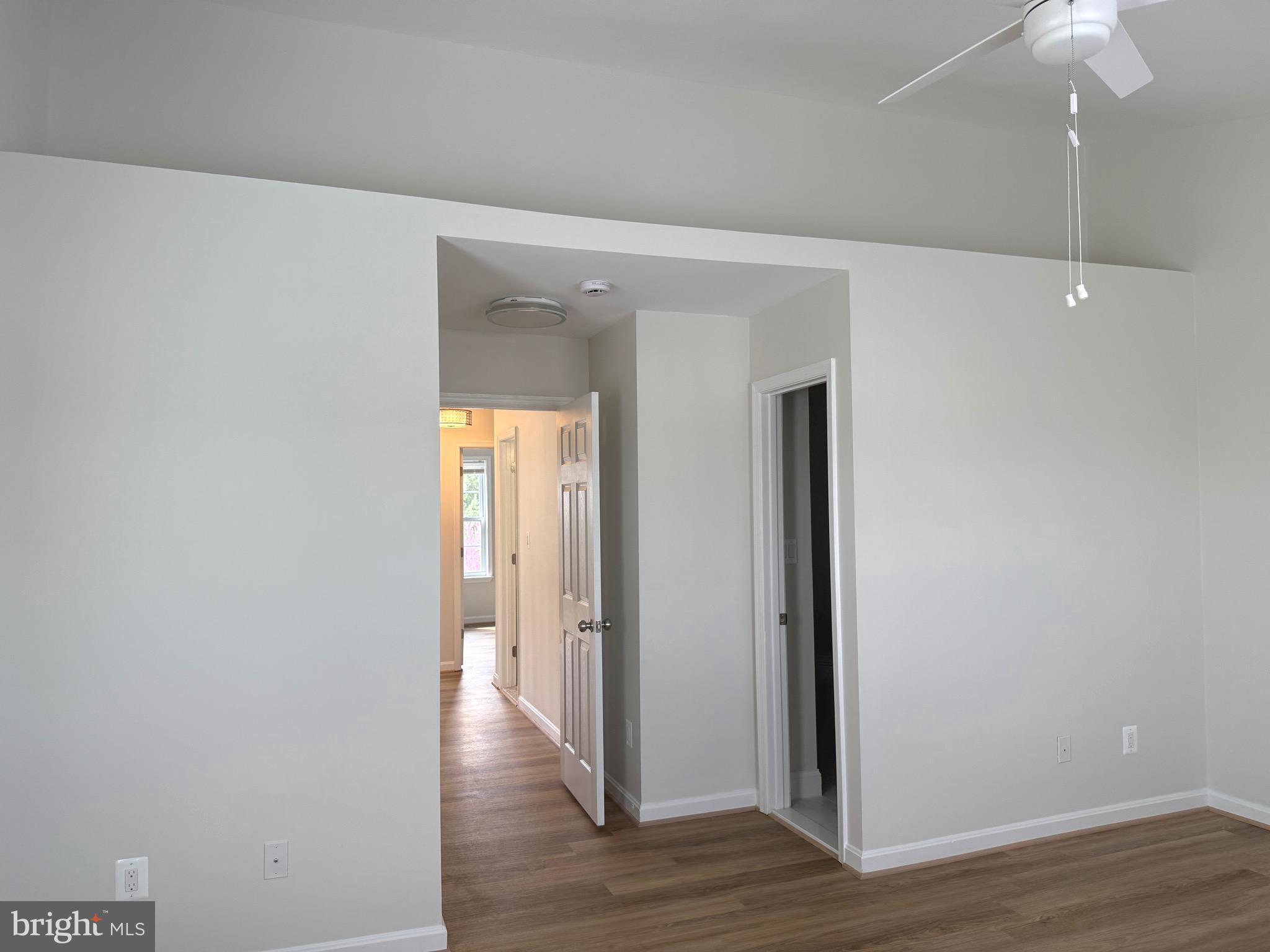21681 Hazelnut Square, Unit 168 Sterling, VA 20164 - Photo 33 of 35 a view of a hallway with wooden floor