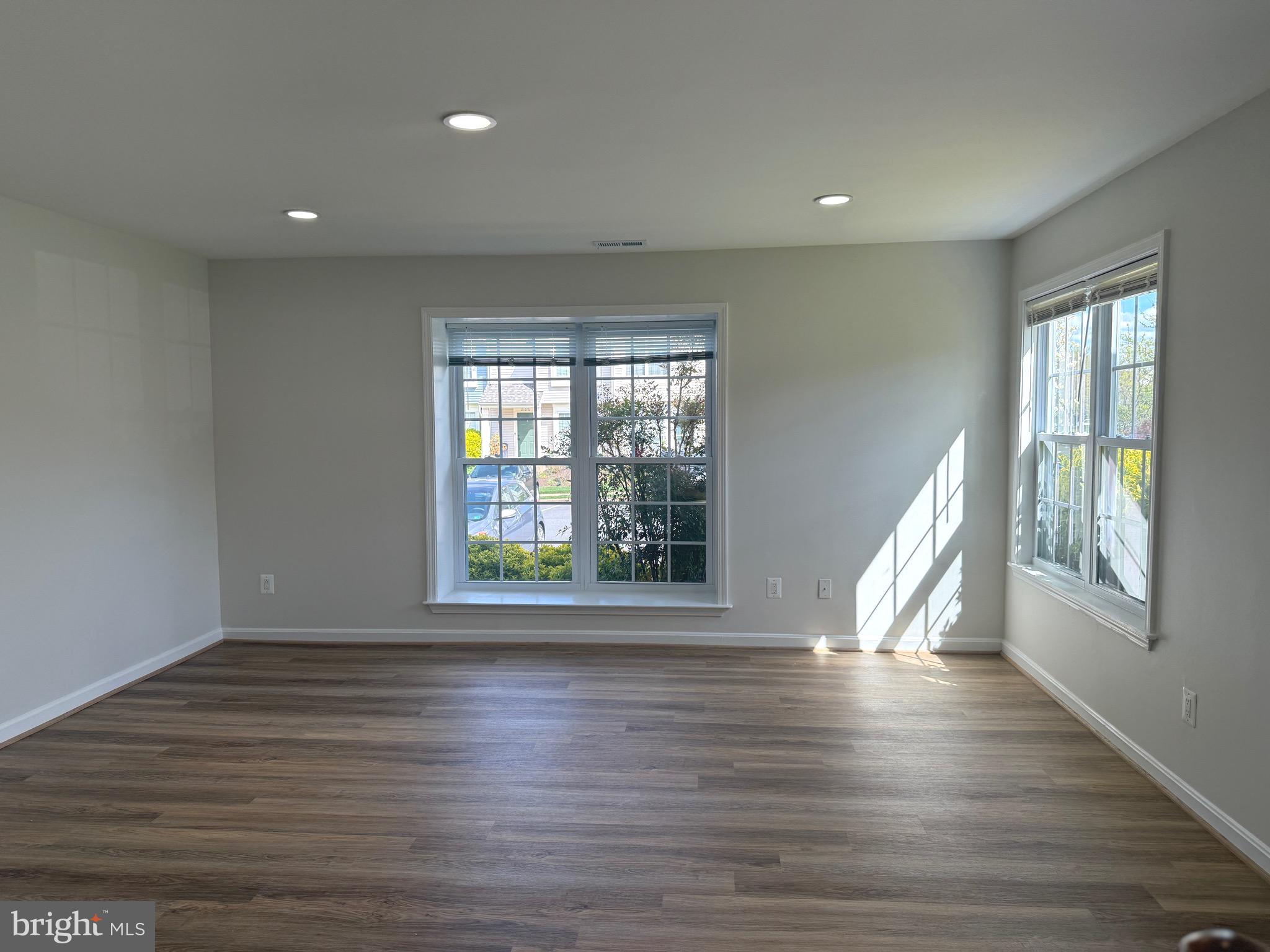 21681 Hazelnut Square, Unit 168 Sterling, VA 20164 - Photo 35 of 35 a view of an empty room with wooden floor and a window