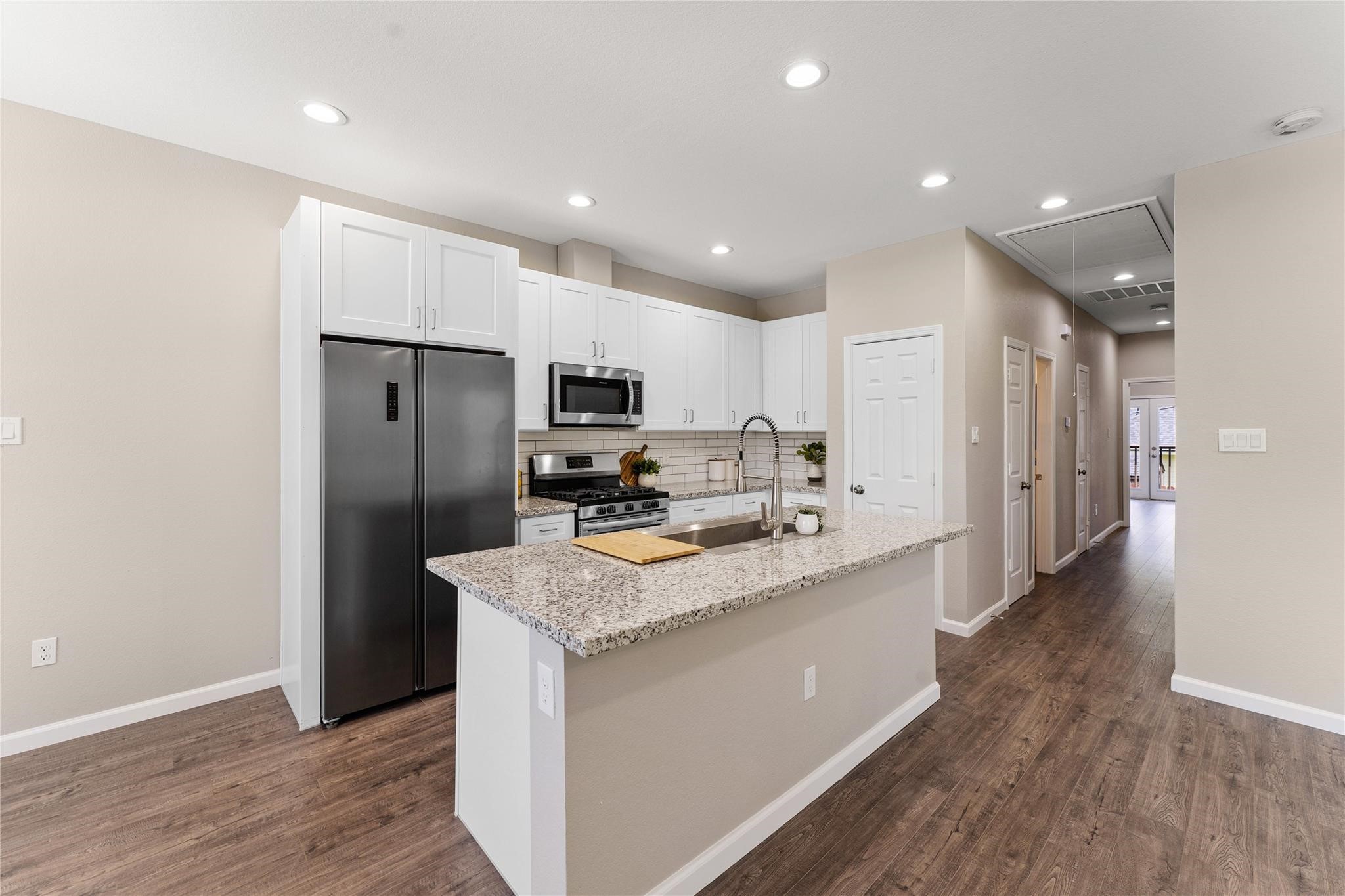 5218 Jezebel Street, Unit B Houston, TX 77033 - Photo 15 of 31 a kitchen with stainless steel appliances granite countertop a lot of counter space and wooden floor