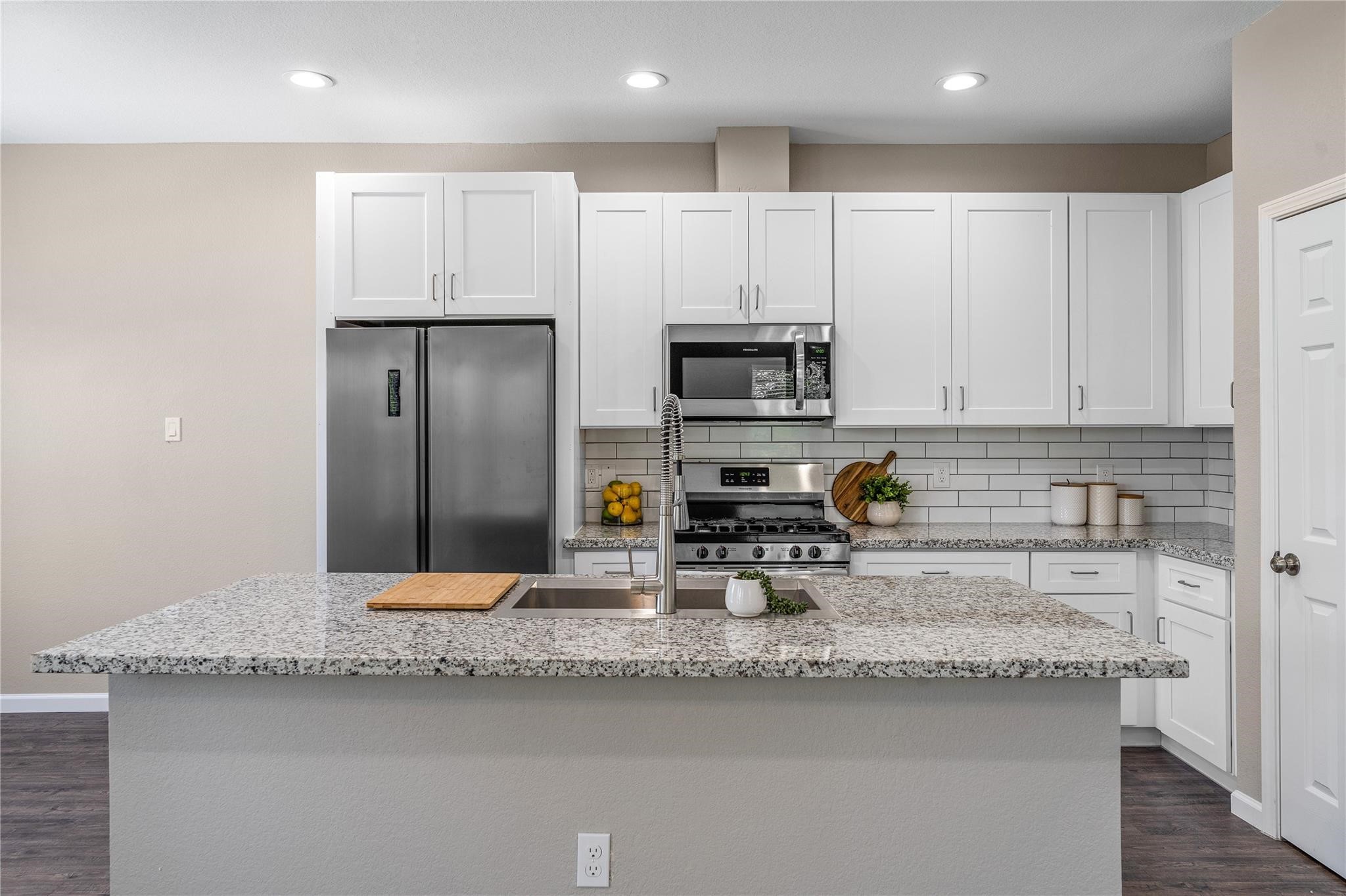 5218 Jezebel Street, Unit B Houston, TX 77033 - Photo 18 of 31 a kitchen with stainless steel appliances granite countertop a sink a stove and a granite counter top