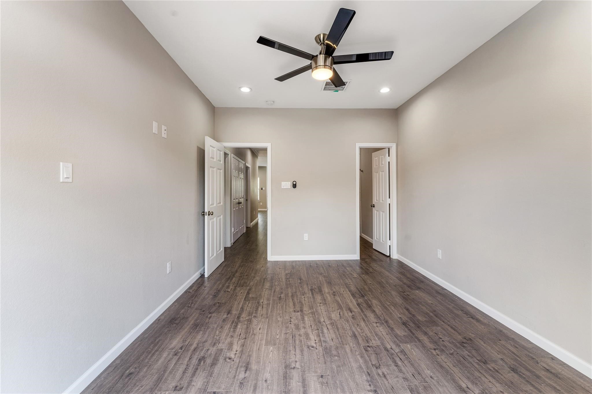 5218 Jezebel Street, Unit B Houston, TX 77033 - Photo 21 of 31 a view of a big room with wooden floor and a ceiling fan