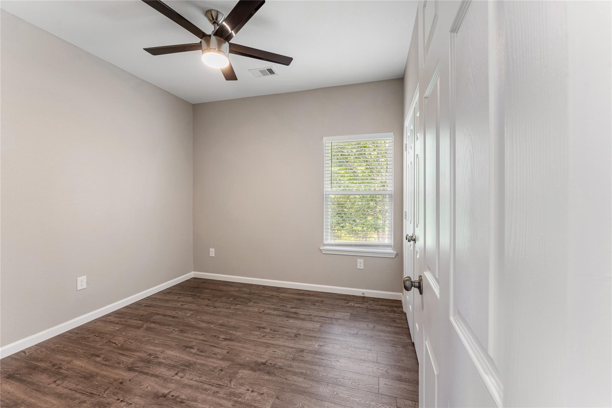 5218 Jezebel Street, Unit B Houston, TX 77033 - Photo 27 of 31 a view of empty room with wooden floor and fan