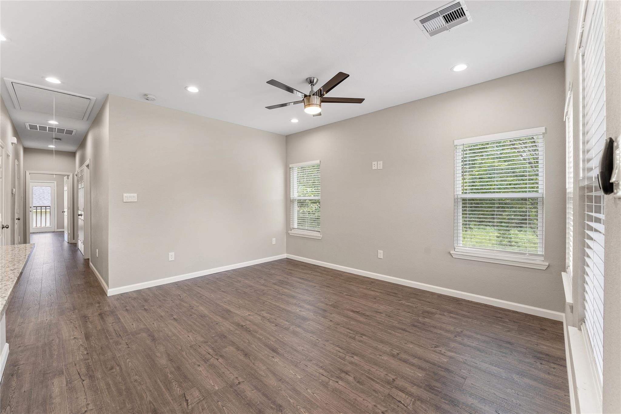 5218 Jezebel Street, Unit B Houston, TX 77033 - Photo 10 of 31 an empty room with wooden floor and windows