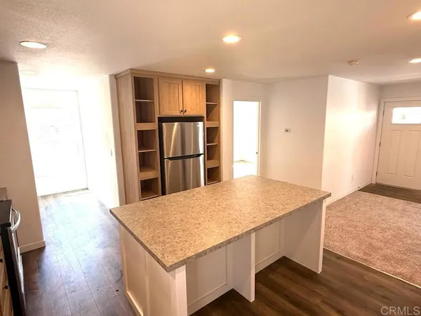 a kitchen with stainless steel appliances granite countertop a refrigerator and a sink