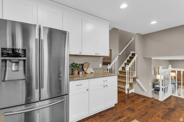 11976 Woodridge Road Sandy, UT 84094 - Photo 7 of 40 Kitchen featuring stainless steel refrigerator, white cabinetry, and a granite countertops