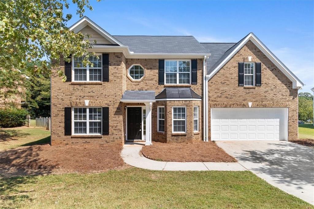 902 Chandler Road Lawrenceville, GA 30045 - Photo 1 of 1 a front view of a house with garage